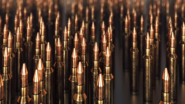 Infinite animation showing a row of bullets. 
Machine gun, rifle ammo on dark background with DOF effect. Ammo packing. Warehouse. 4K seamless loopable background.