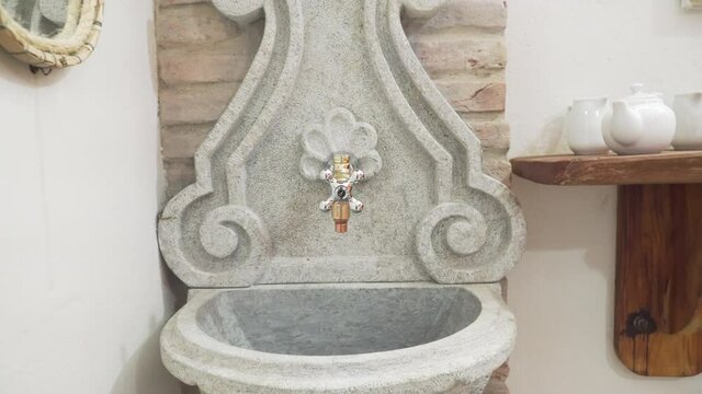 zoom out on details of soapstone washbasin with baroque design, colonial Brazil style