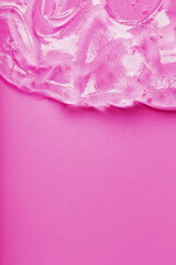 Transparent liquid gel on a pink background with free space.