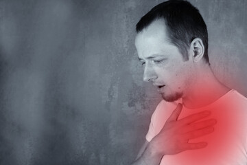 Man with chest pain, acid reflux, heartburn cough or pneumonia, black and white photo with red pain area