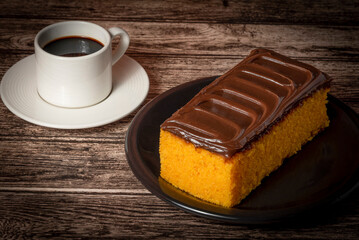 carrot cake on a plate with coffee