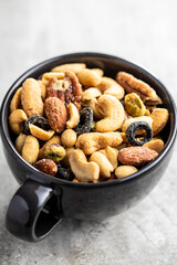 Mix of salted nuts in cup.