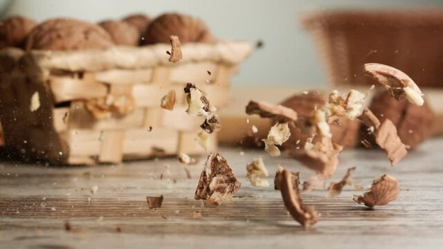 Walnut crushed and broken by a hammer blow in slow motion