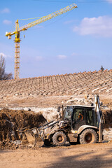 Tractor and Crane workig to Construction of a New Stadium.