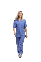 Full length portrait of a female health care worker in a blue uniform walking towards camera