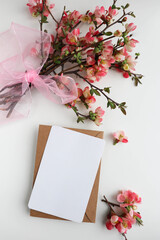 mockup greeting card from flowering branches, envelope and white blank for text 