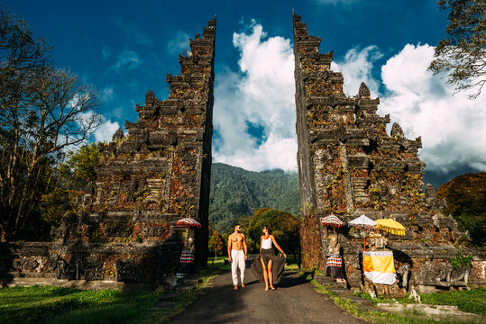 Traveling couple in Bali. Happy couple vacationing in Asian countries. Couple at the Bali gate. A man and a woman traveling on the island of Bali Indonesia. The couple is traveling in Indonesia