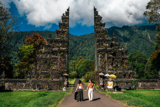 Traveling couple in Bali. Happy couple vacationing in Asian countries. Couple at the Bali gate. A man and a woman traveling on the island of Bali Indonesia. The couple is traveling in Indonesia
