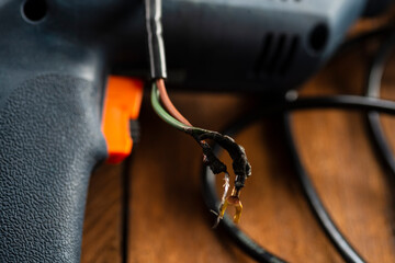 Burning wires on parts of an electrical appliance in a repair shop. Power tool repair