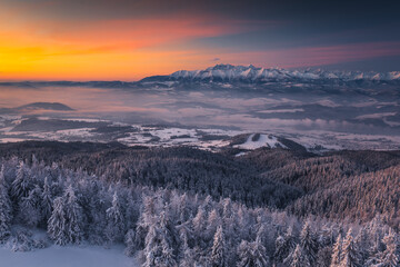 Winter morning in Gorce on the tower on the top of Lubań. A beautiful, romantic atmosphere with a view of the Pieniny Mountains, the Beskids and the Tatra Mountains.
