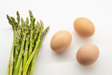 Asparagus and eggs on white background

