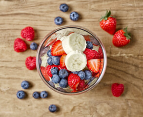 glass of fresh banana and berries