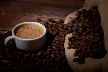 A sack of coffee beans on a wooden board
