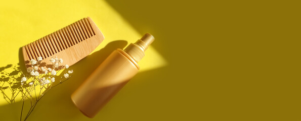  shampoo, wooden comb on a colored background