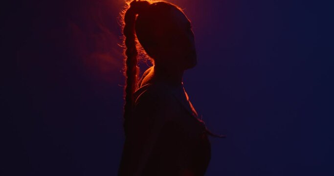 Cool girl dancing hot passionate dance in spot light. Professional female performer, expression and rhythm