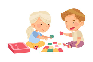 Happy Little Boy and Girl Playing Jigsaw Puzzle on the Floor Vector Illustration