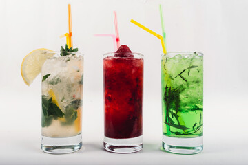 Cocktail set on a white with fresh summer fruits. Isolated.