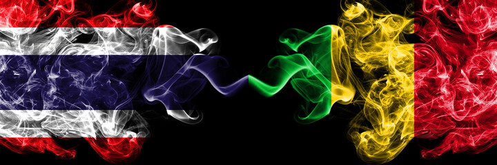 Obraz premium Thailand, Thai vs Mali smoky mystic flags placed side by side. Thick colored silky abstract smokes flags.