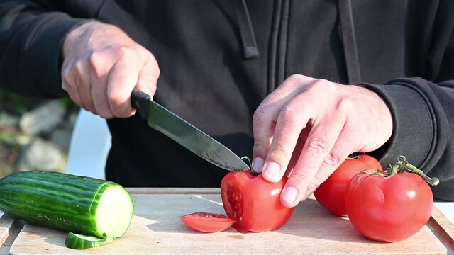 Man with a black sweatshirt preparing vegetables