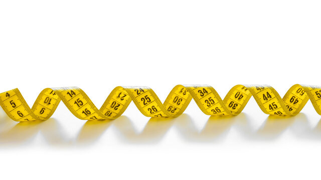 Yellow isolated metric measuring tape isolated on white background. Centimeter, close-up