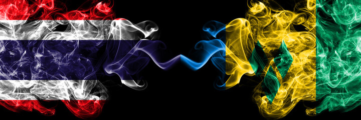 Thailand, Thai vs Saint Vincent and the Grenadines smoky mystic flags placed side by side. Thick...