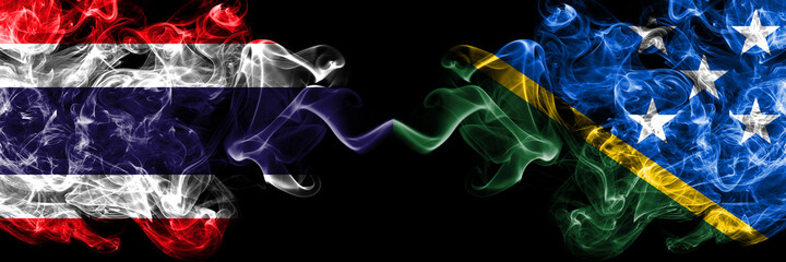 Thailand, Thai vs Solomon Islands smoky mystic flags placed side by side. Thick colored silky abstract smokes flags.
