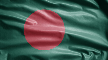 Bangladeshi flag waving in the wind. Close up of Bangladesh banner blowing silk.