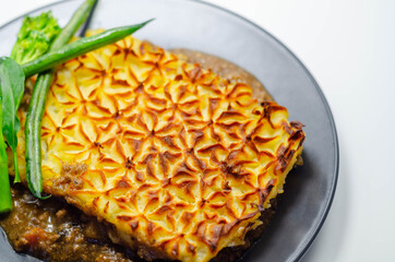 Tender minced lamb with garden veg in a hearty gravy beneath butter mash, typical Shepherd's pie