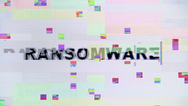 Intentional glitch distortion noise effect on a computer monitor while typing the word Ransomware. Macro detail shot.
