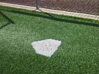 a practice diamond inside a batting warm-up area at a baseball field