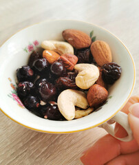 Group of mixed nuts and berries. Cashews, almonds, hazelnuts, black currants. Healthy food and snack