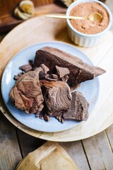 large and small pieces of dark chocolate. chocolate is an ingredient for making dessert. crushed chocolate. pieces of dark chocolate top view. chocolate and cocoa macro photo