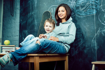 little cute boy in glasses with young real teacher, classroom studying, lifestyle people concept © iordani