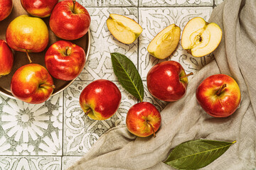 Plate with ripe multicolored apples on rustic tile.Top view.Still life.