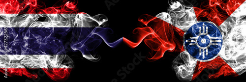 Thailand, Thai vs United States of America, America, US, USA, American, Wichita, Kansas smoky mystic flags placed side by side. Thick colored silky abstract smokes flags.