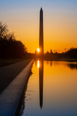Fototapeta na wymiar Rising Sun Shines Between the US Capitol and the Washington Monument at the Equinox