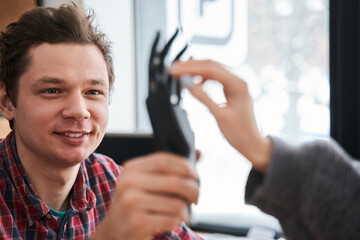 Engineer showing a new artificial limb for his client or patient