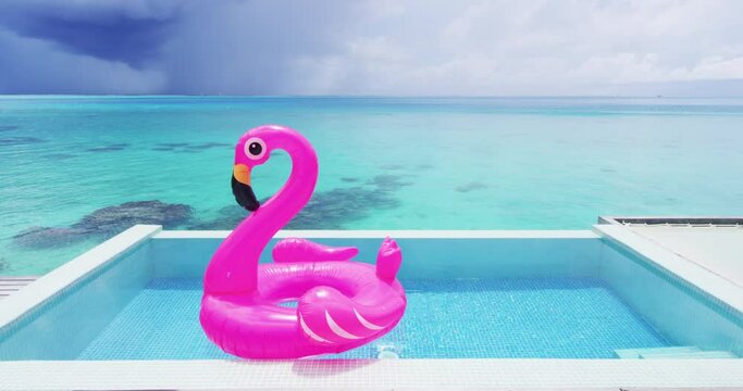 Travel Vacation Pool Beach travel concept with inflatable pink flamingo float toy mattress in luxury swimming pool. Luxury lifestyle summer holidays travel background video in slow motion.