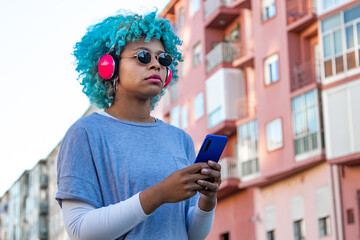 Fototapeta na wymiar afro american girl with mobile phone and headphones