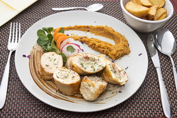 rolled chicken with vegetables on a plate
