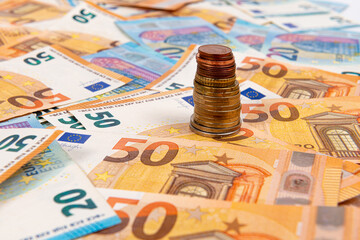 coins on the background of euro banknotes, Euro bill as part of the economic and trading system