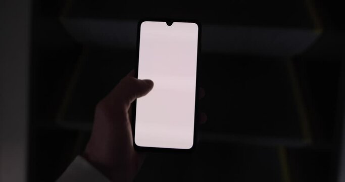 Male hand holding smartphone mockup going on escalator swipe left touchscreen empty screen chromakey