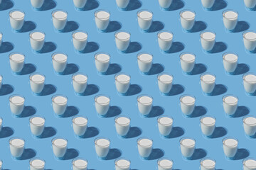 World Milk Day. Pattern on a blue background. A glass of milk. Pattern.