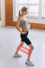 Girl doing stretching exercises in the gym. Sport, healthy lifestyle concept