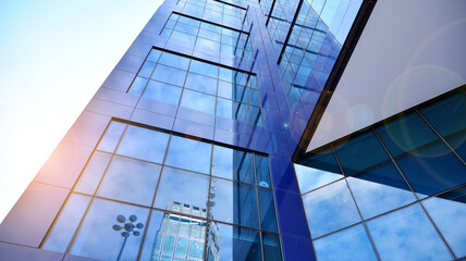 Obraz premium Glass clad facade of a modern building covered in reflective plate glass.