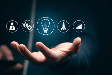 man holding phone with start up icons