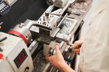 Man engineer standing at the special machine and working while developing