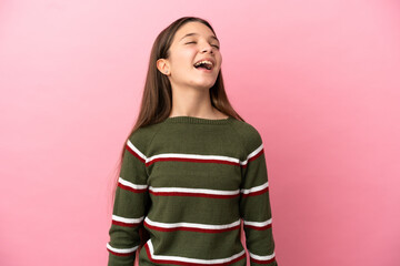 Little girl over isolated pink background laughing