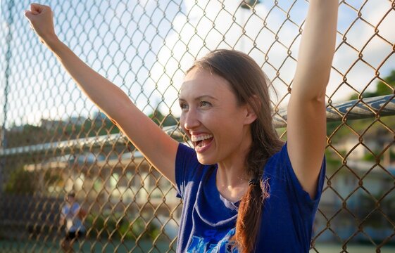 Mother Cheering And Praising Her Child At A Field Game. Happy Parents Watching Kids Sports Outside.