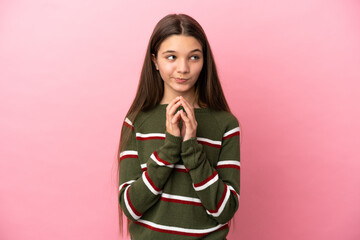 Little girl over isolated pink background scheming something